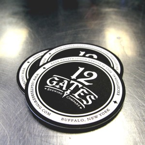 12 Gates Brewing Company coasters. Black with a white logo centered