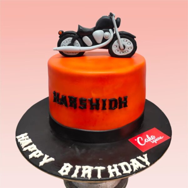 Eye-catching 1kg Stylish Boys Bike Cake showcasing a fondant bicycle in vibrant colors, with realistic wheels and chain details. Decorated with "Happy Birthday" text and age number for a young cycling enthusiast.