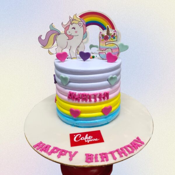 Amazing Unicorn Theme Birthday Cake 2 Kg Two-tier white and pastel cake with fondant unicorn topper, rainbow mane, and gold accents