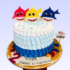 A colorful Baby Shark-themed birthday cake 1kg, featuring Baby Shark and family in an underwater adventure design, perfect for young children.