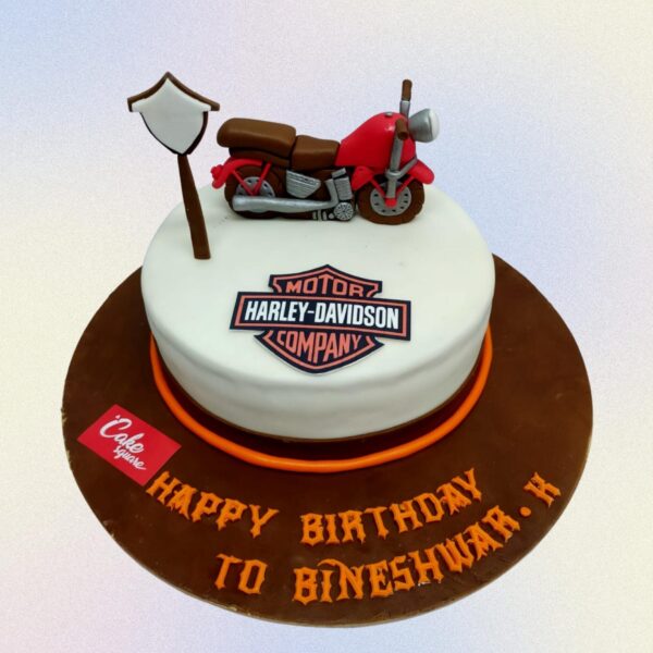 Beautiful Bike Husbands Birthday Cake 1 Kg featuring a fondant motorcycle, realistic tire treads, and metallic accents. Personalized with a "Happy Birthday" message for a bike-loving husband.