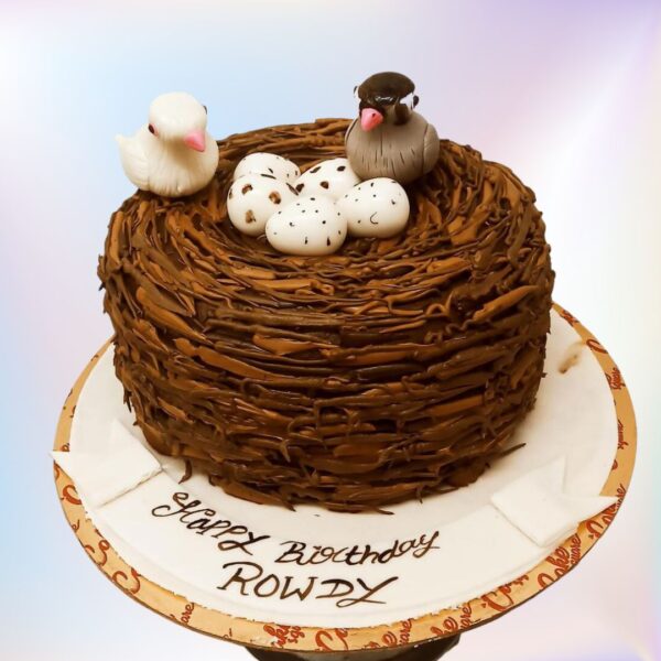 Beautiful Birds Nest Theme Birthday Cake 2 Kg with textured "twigs", fondant blue eggs, perched fondant birds, and delicate sugar flowers, nestled on a tree bark-textured base.