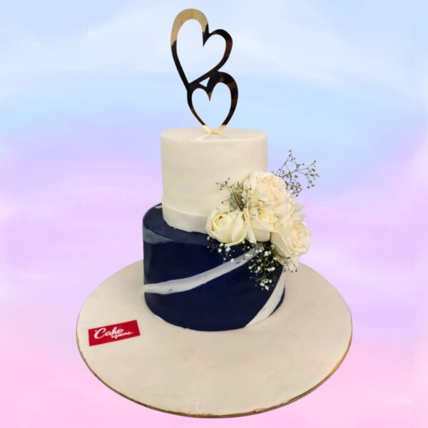 Best Elegant Engagement Cake 3 Kg with white fondant, silver accents, and delicate sugar flowers cascading down the side.