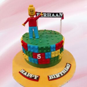 Vibrant Best Lovely Legos Theme Kids Birthday Cake 1 Kg featuring colorful fondant bricks, mini Lego figurines, and a personalized nameplate made of edible Lego pieces.