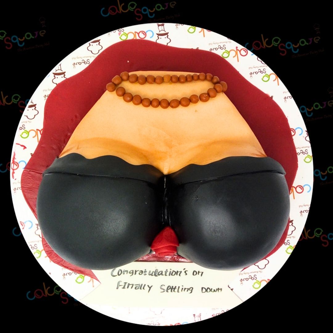 A Black Boobie Cake, featuring a bold and cheeky design, displayed on a festive table, ready to add a fun and playful touch to an adult celebration or bachelorette party.