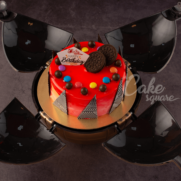 A black bomb shell with a lit candle on top filled with our Blueberry Blast Half Kg Bomb Birthday Cakes with lots of chocolates to surprise. Made by Cake Square Team