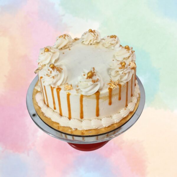 Caramel Butterscotch 1 Kg Birthday Cake with white ruffles with gold sprinkles and caramel drippings on all sides.