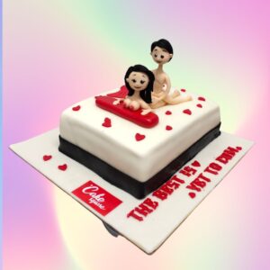 A creatively designed adult-themed cake featuring a romantic couple motif, suitable for private celebrations between partners.