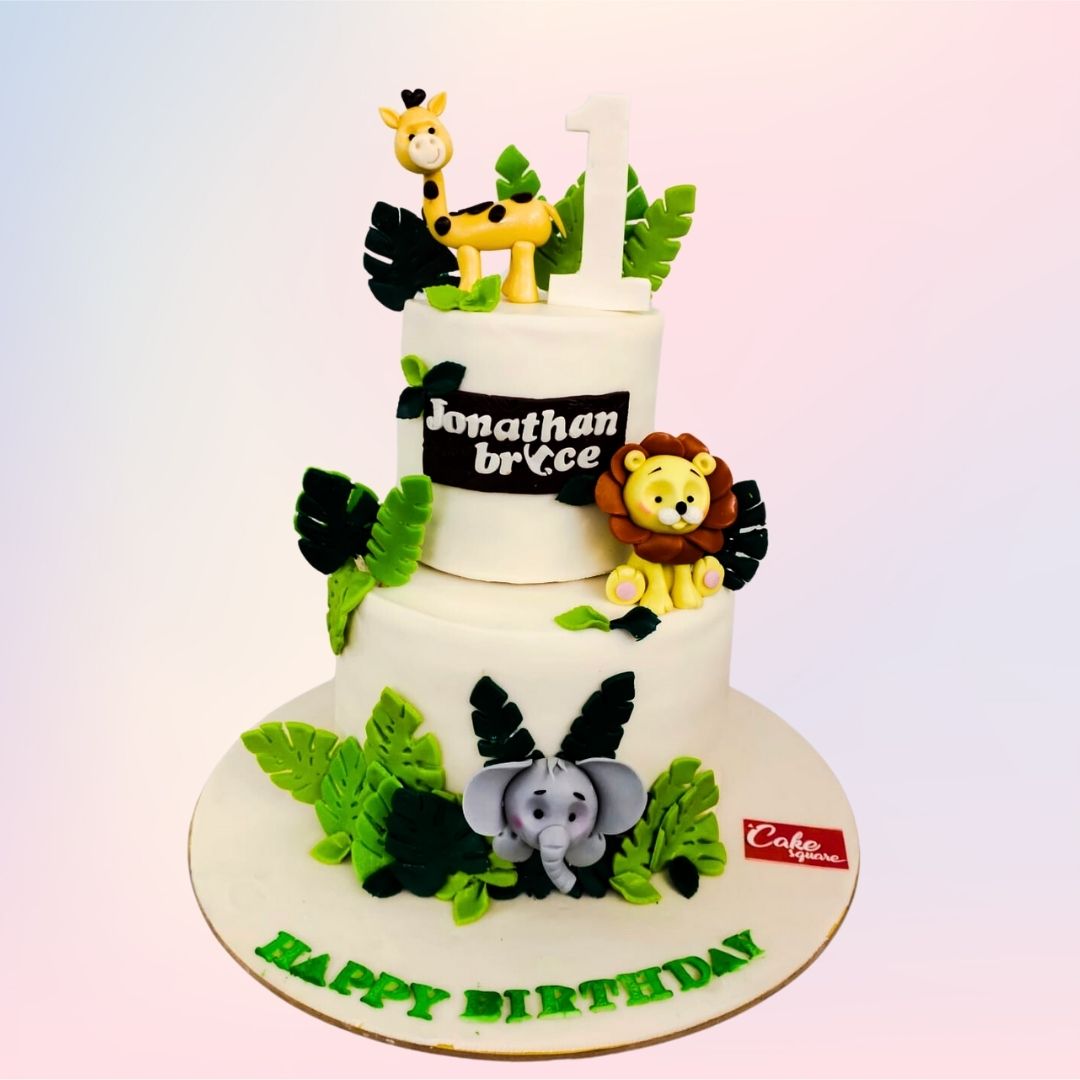 A charming Cute Animal First Birthday Cakes 5 kg, featuring a variety of adorable jungle animals in a vibrant and playful design, perfect for a baby’s first birthday.