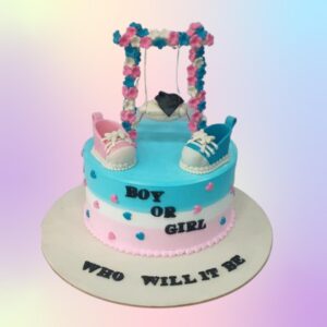 Cute Gender Reveal Cake 1 Kg with a smooth white fondant exterior decorated with pink and blue question marks. The cake is topped with a fondant stork carrying a bundle. "Boy or Girl?" is elegantly written across the front.