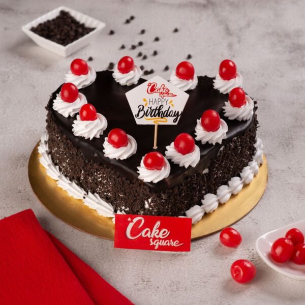 The Delicious Heart Black forest 1 kg birthday Cake is topped with bright cherries making it the perfect addition to your birthday or anniversary party.