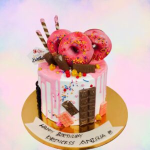 "Donut Birthday Cakes 1 Kg Birthday Cakes. Donut-themed chocolate dripping cake, perfect for birthdays from Cake Square Chennai."