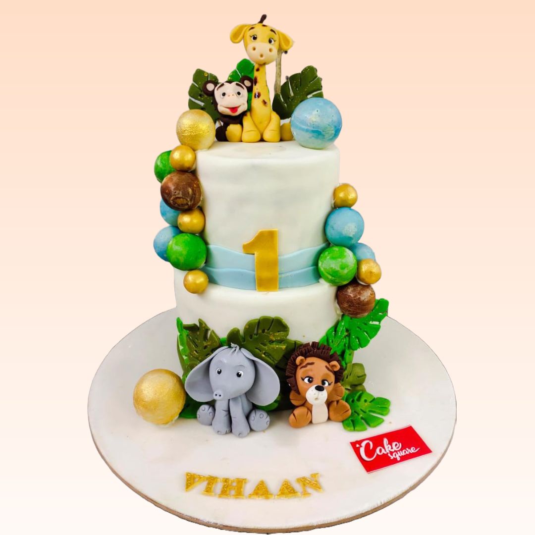 Elegant Animal Theme 4 Kg First Birthday Cake.Sophisticated 4 Kg animal-themed first birthday cake with gold accents and fondant figurines.