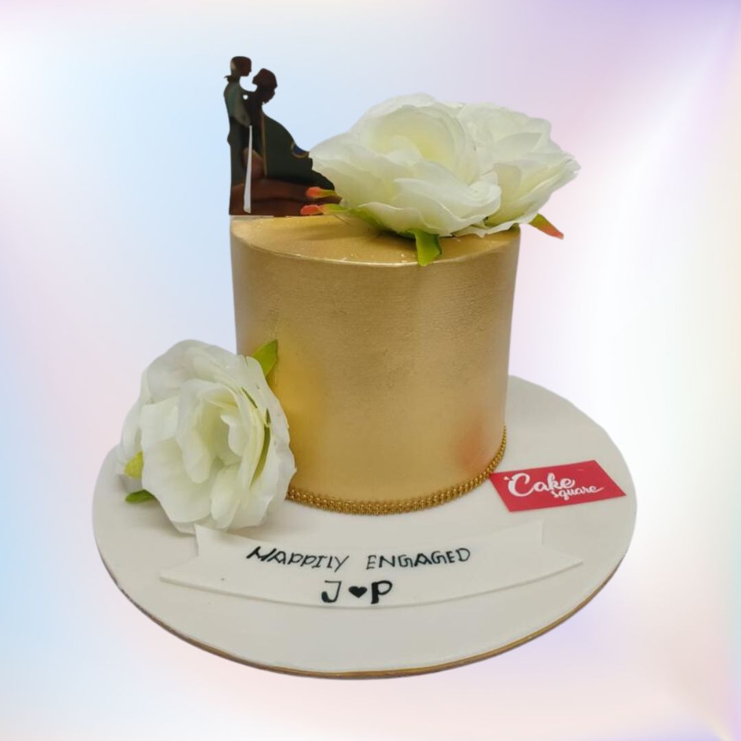 A gold finished cake with two big white flowers handmade with fondant and a lovely couple topper is our Elegant bride to be cakes 1 Kg. Made by Cake Square Team.