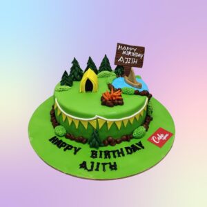 Fearless Camper Theme Birthday Cake 1 Kg - round cake with miniature tent, campfire, and forest-inspired decorations