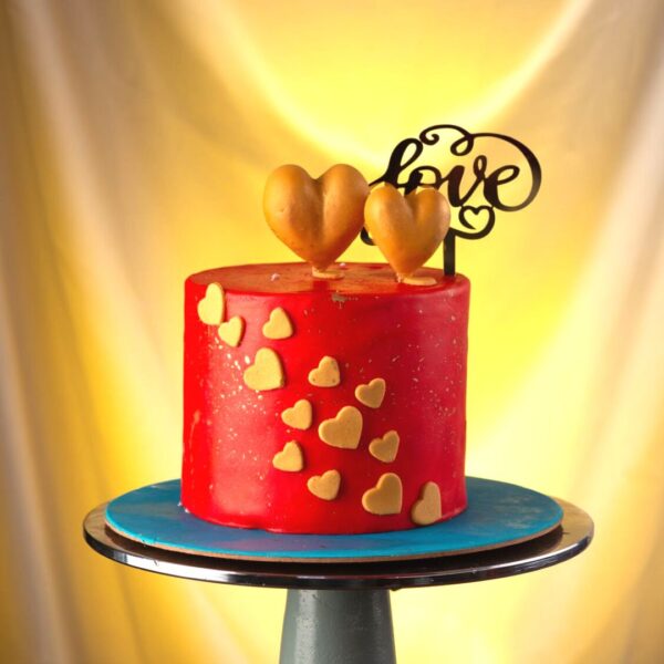 Double Golden hearts 1 Kg Anniversary Cake with 3d hearts on top of a red cake just to say i love you made by Cake Square.