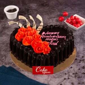 A heart-shaped 1/2 Kg Chocolate Birthday Cake with smooth frosting, piped border,