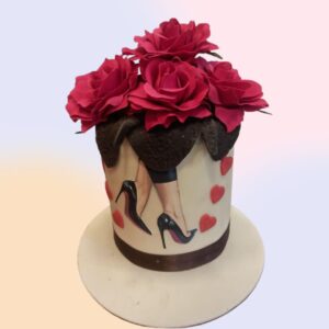 A cute tall cake filled on top with red roses and an edible photo cake of heels on the side is our Heels Over Head Theme bride to be Cakes 2 Kg. Made by Cake Square Team.