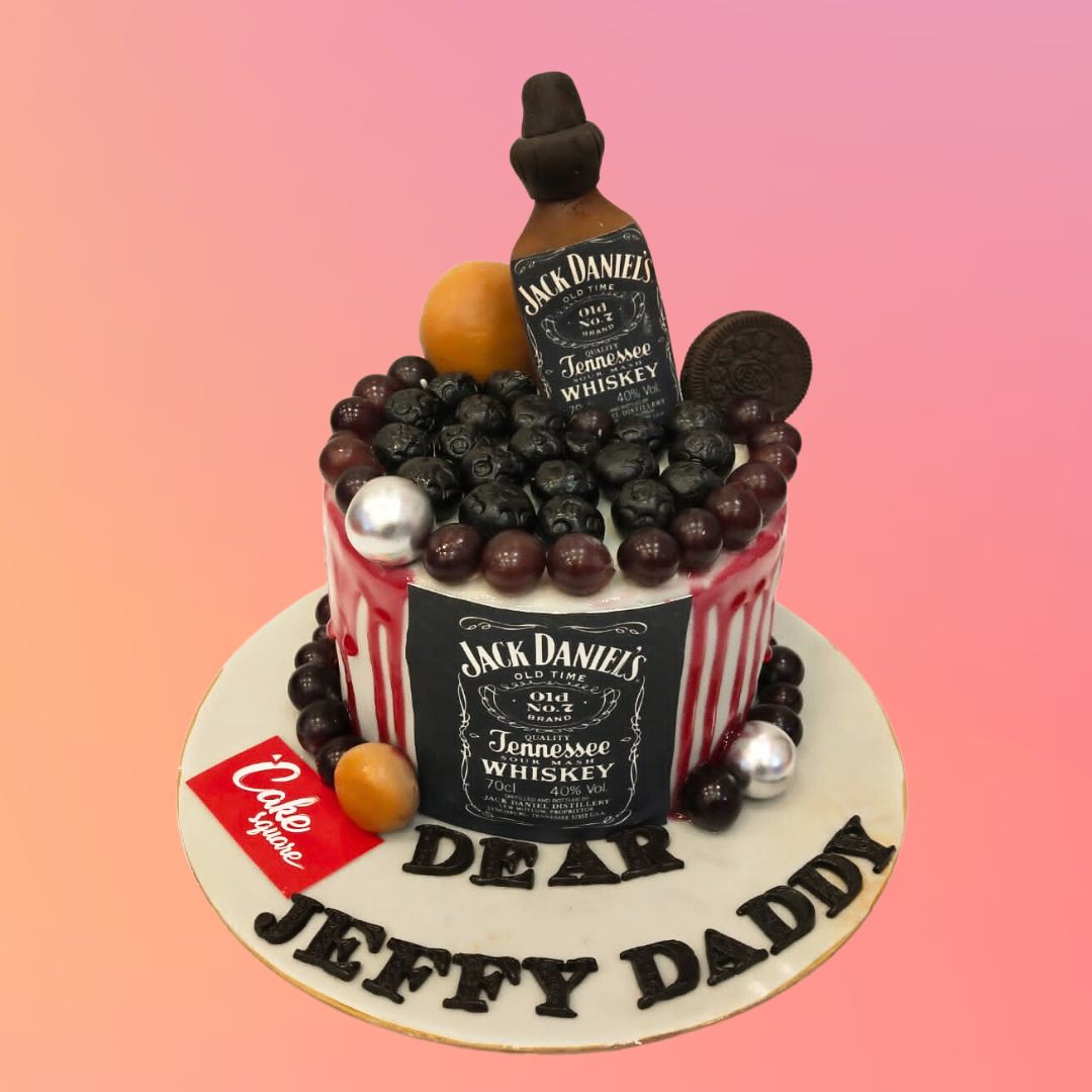 A creatively designed Jack Daniel Liquor Theme Cake featuring realistic whiskey bottle details and festive decorations, ideal for celebrating special occasions.