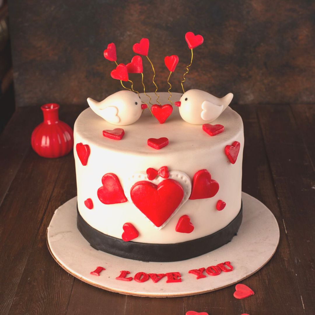 Two cute 3d birds on top make the Love Birds 1 Kg Anniversary Cake adorable.