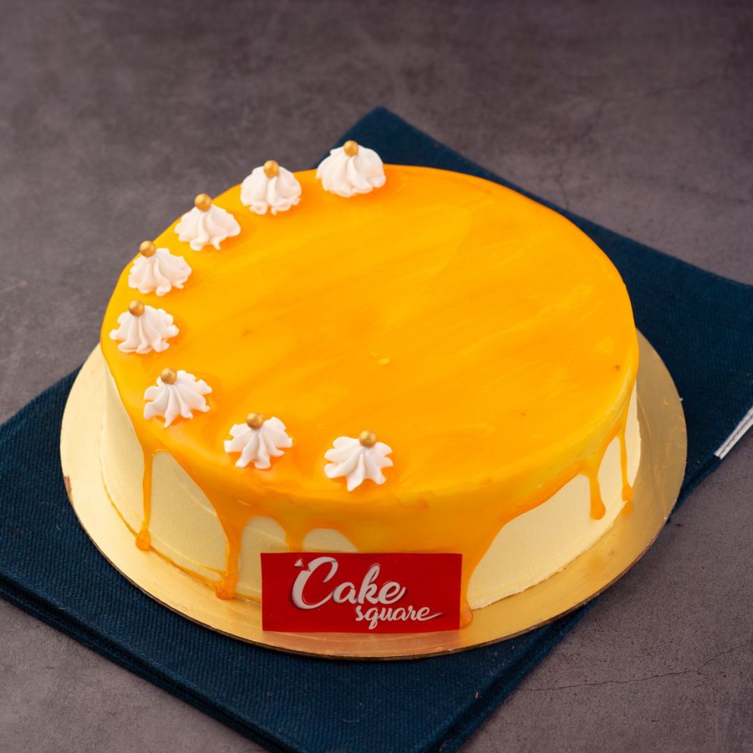 A round cheese cake is yellow in colour topped with mango crush is our Mango Cheese Cake 1/2 kg Birthday Cakes. Made by Cake Square Chennai.