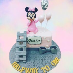 "Minnie Theme Half Birthday Cake 1 Kg with cute Minnie Mouse decorations, perfect for a playful half-birthday celebration."