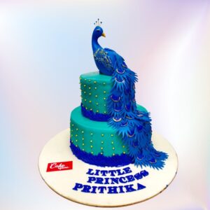 Pretty Peacock 4 Kg 1st Birthday Cake,Stunning 4kg cake shaped like a peacock, featuring vibrant blue and green fondant feathers, gold accents, and a "1" topper for a luxurious first birthday celebration.