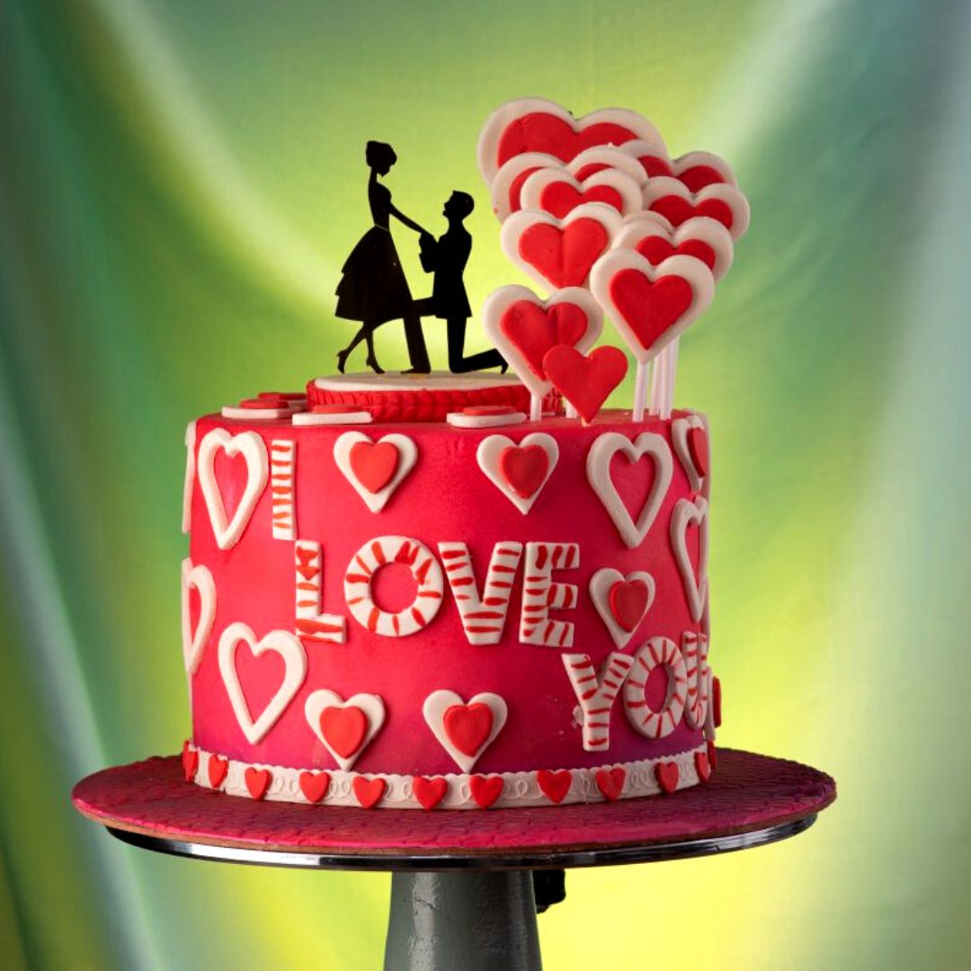 A cake filled with 3d double hearts and a couples with cute toppers in Promising Love 1 Kg Anniversary Cake by Cake Square Chennai.