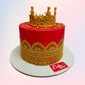 A red cake made tall in 2 Kgs with a golden crown for the brideand decorated with golden lace on the sides of the cake is our Queen Of Love 2 Kg bride to be Cakes. Made by Cake Square Team