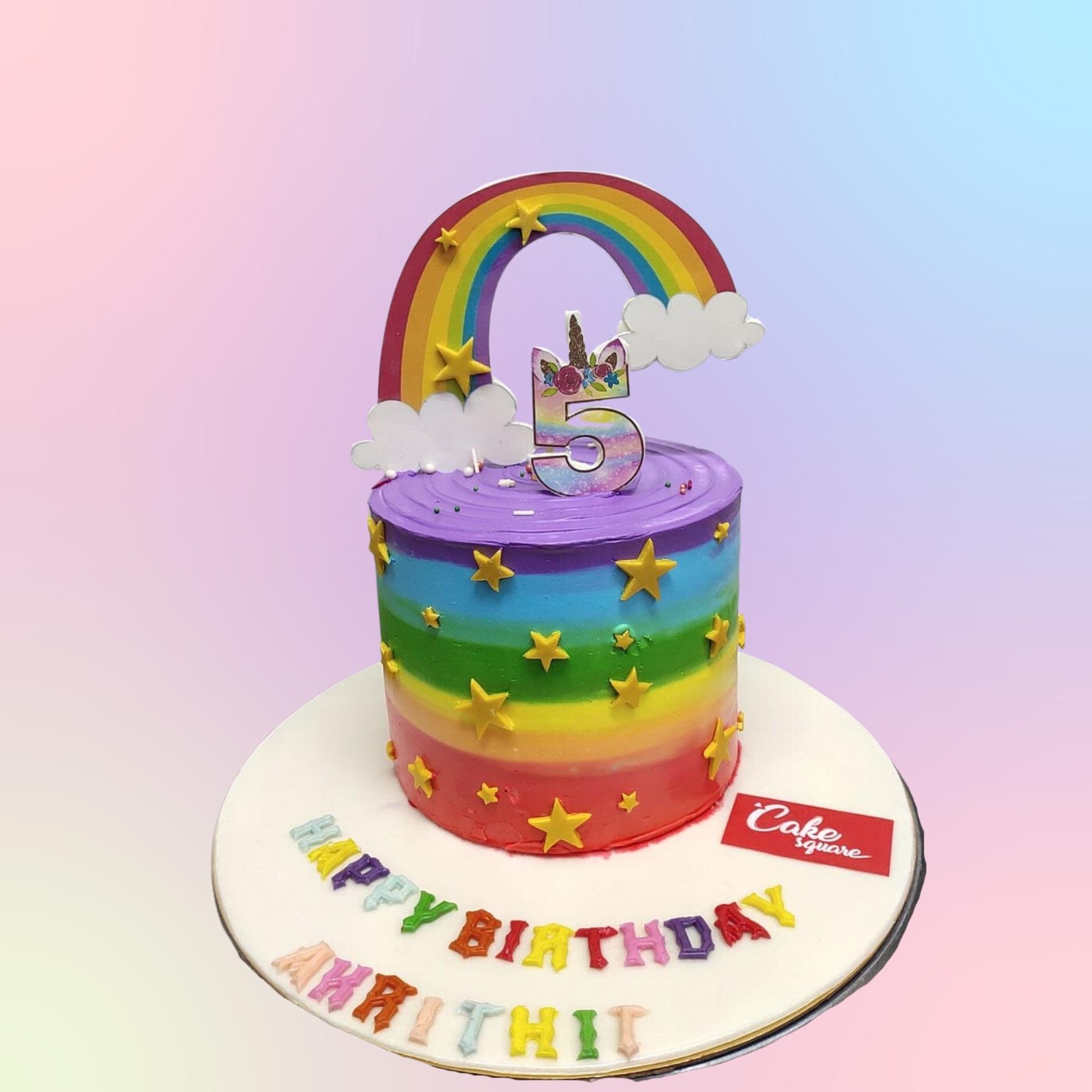 Rainbow Theme Girls Birthday Cake 1 Kg - round cake with vibrant rainbow layers and colorful cloud-like frosting decorations