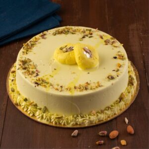 A round Special Rasamalai 1/2 Kg Birthday Cakes topped with real rasamalai and pistachio.