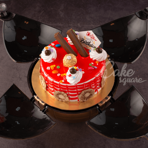 A red strawberry cake with extra chocolate Decorationkit kats, ferraro rochers and piping of whipped cream with cherries is our Strawberry Bomb 500 gms Birthday Cakes. Made by Cake Square Team