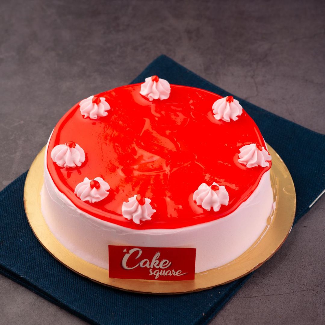 A round cheese cake that is dressed with strawberry on the top and touch of chocolate ganche is our Strawberry Cheese Cakes 1 Kg Birthday Cakes.Curated by Cake Square Team.