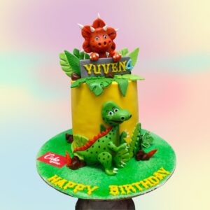 Superb Dinosaur Theme Kids Birthday Cake 1 Kg,Charming 1 kg round cake decorated with fondant dinosaurs, prehistoric plants, and a volcano, creating a fun Jurassic scene for a child's birthday.