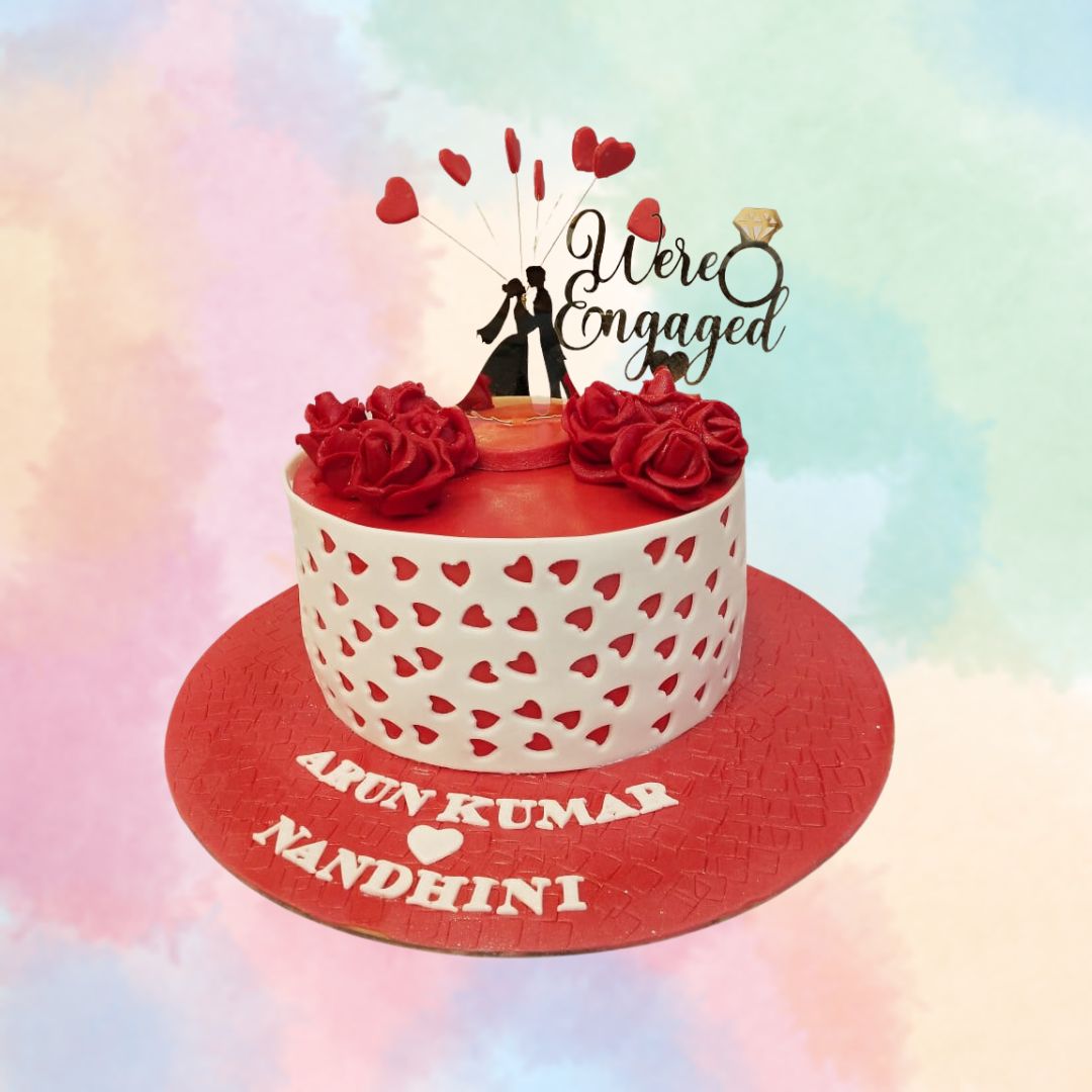 Superb We're Engaged Theme Cake 1 Kg. A delightful 1 kg engagement cake with “We’re Engaged” written in elegant script, surrounded by beautiful decorations, perfect for announcing your big news.