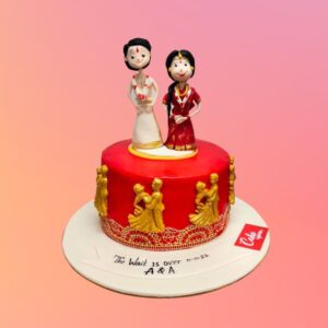 A red cake with couples dancing on the side and a golden frill and a really traditional couple fondant cake topper is our Traditional Couple 1 Kg Anniversary Cake by Cake Square.