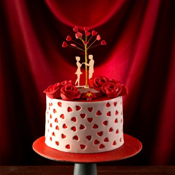 A couple declaring love under a tree with open hearts is Tree Love Cake 1 Kg Anniversary Cake.