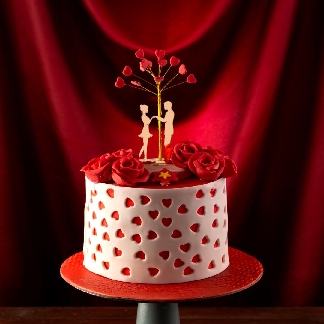 A couple declaring love under a tree with open hearts is Tree Love Cake 1 Kg Anniversary Cake.