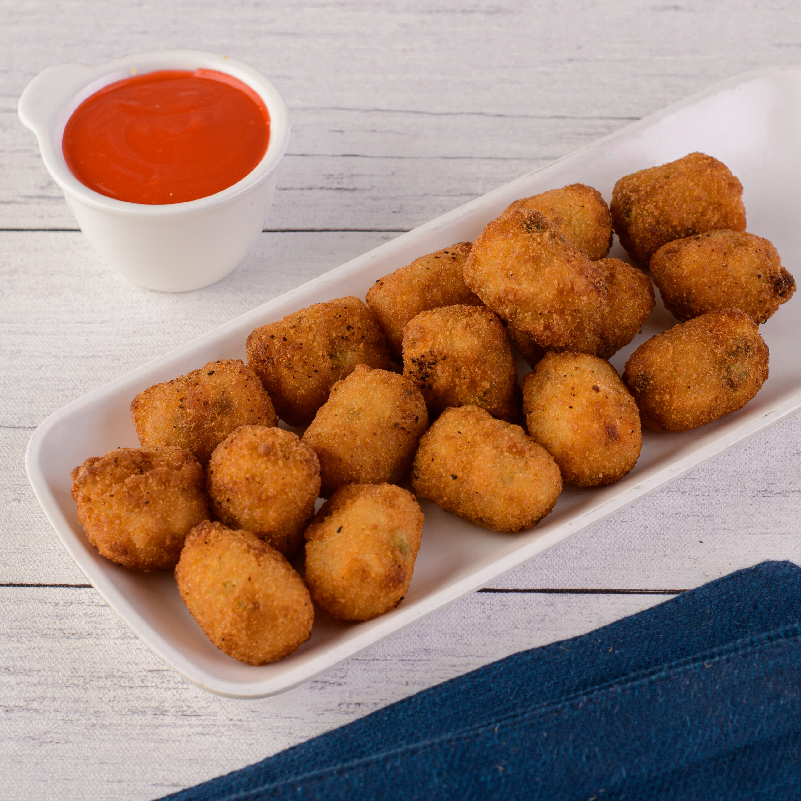 Veg Nuggets 8 Pieces. Golden-brown vegetable nuggets, 8 pieces on a serving plate.