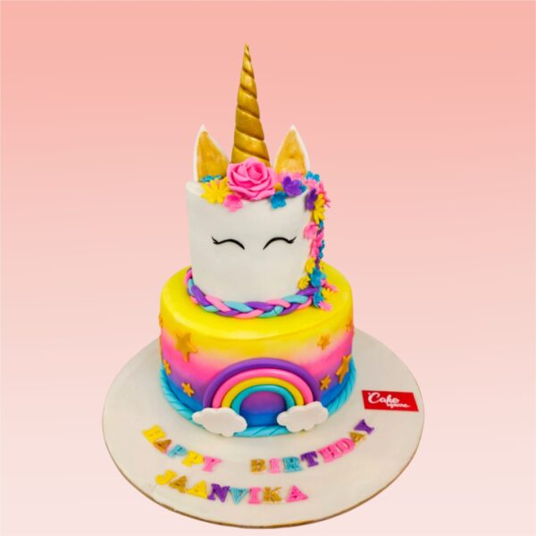 2-Tier Amazing Unicorn Rainbow Birthday Cake 5 Kg. Spectacular two-tiered cake with unicorn figure and cascading rainbow colors for a magical birthday