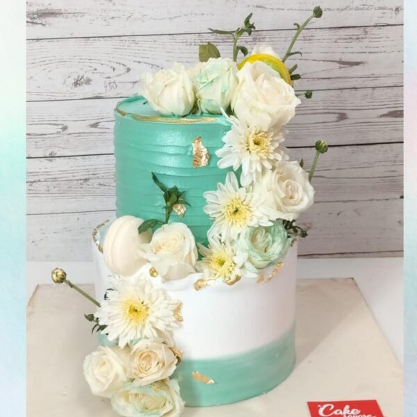 Amazing White And Green Engagement Cake 5 Kg with crisp white tiers, adorned with cascading green foliage and white floral accents.