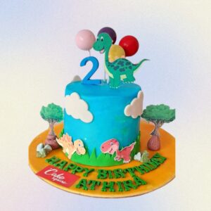 Charming Best Darling Dinosaur Birthday Cake 1 Kg featuring a friendly cartoon dinosaur, prehistoric plants, and colorful volcanic details