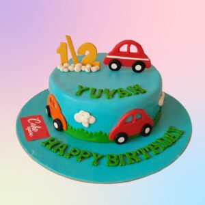 "Cars Theme Half Birthday Cake 1 Kg with fun car decorations, perfect for celebrating a baby’s half-birthday in style."