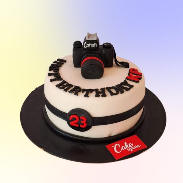 Stylish Cool Camera Theme Birthday Cake 1 Kg shaped like a vintage camera with intricate lens and film roll details