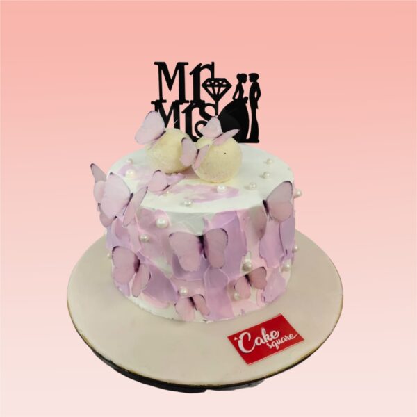 "Creamy Butterfly Mr And Mrs 1 Kg Anniversary Cake, featuring elegant butterfly decorations for a romantic celebration."