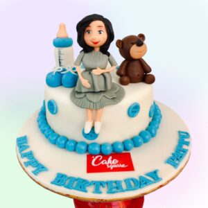 1 Kg Red Velvet cake with Mom To Be Boy or Girl Theme design, featuring gender-neutral baby motifs and decorations.