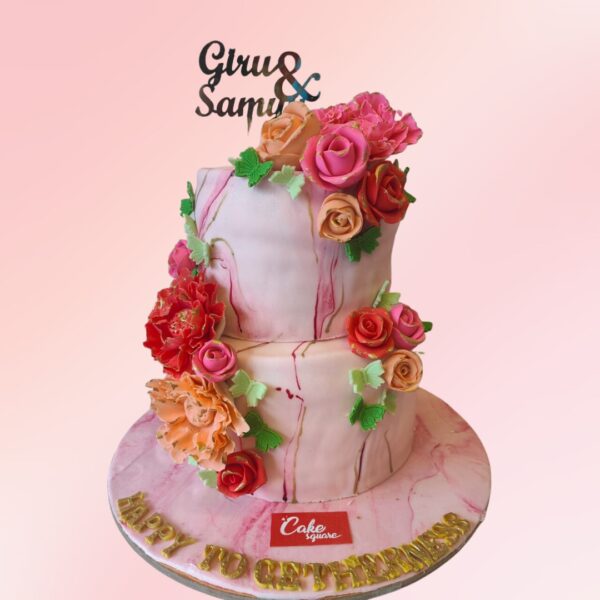 Pink Flowers Engagement Cake 4 Kg with blush pink fondant, adorned with a cascade of handcrafted sugar flowers in various pink shades.