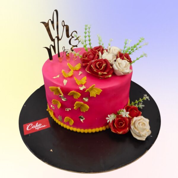 A mini pink cake decorated with hand made sugar butterflies and roses in strawberry flavour is our Roses Anniversary Cake 1 Kg by Cake Square Team