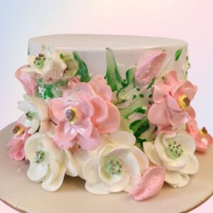 A nice white cake surrounded with pink edible flowers and a touch of green leaves Girls 1Kg Birthday Cake by Cake Square Chennai.