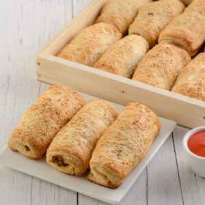 Hot Veg Roll Bulk ordering. Steaming hot vegetable rolls wrapped in golden pastry, arranged for bulk order.